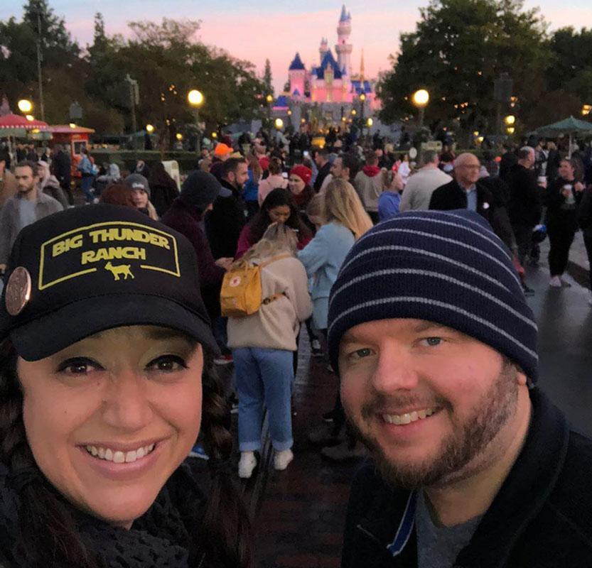 Chuck and Amy at Disneyland in front of the castle
